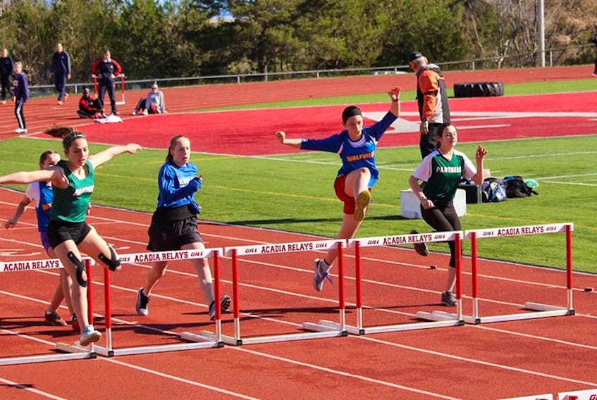 Student athletes make their way over the hurdles at the NSSAF Track and Field Kings-Hants district competition at Acadia University in May 2019.