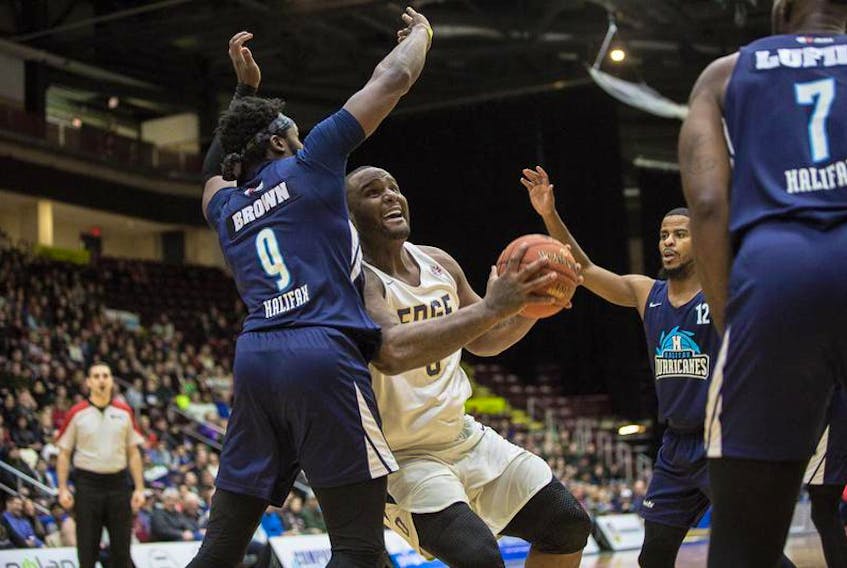 Rhamel Brown of the Halifax Hurricanes defends against Glen Davis of the St. John’s Edge during a National Basketball League of Canada game Tuesday night at Mile One Centre in St. John’s, N.L. Looking on are Cliff Clinkscales (12) and Chadrack Lufile (7) of the Hurricanes, who won the game 104-70.