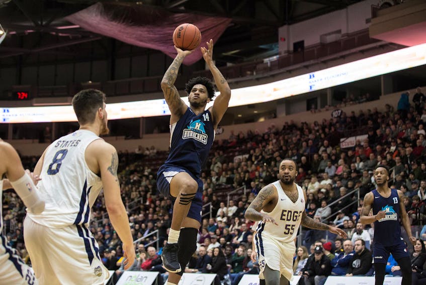Jordan Washington of the Halifax Hurricanes shoots as Brad States and Junior Cadougan (55) of the St. John’s Edge look on during Thursday’s NBL Canada game at Mile One Centre in St. John’s, N.L.