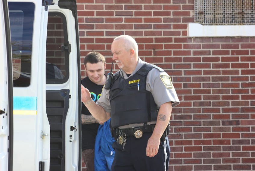 Myles Walter Card, left, of Windsor, is led to a sheriff’s van at Windsor provincial court in 2015.