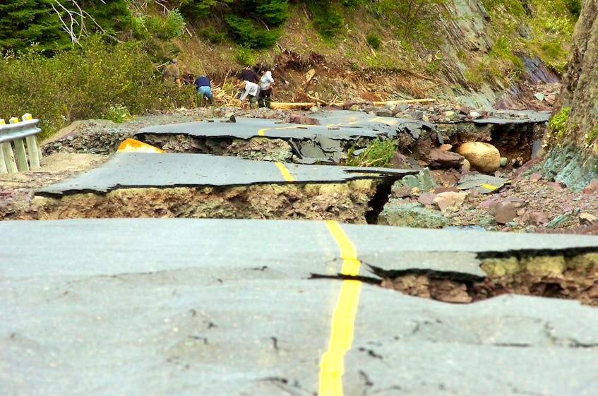 In this file photo from September of 2010, the road to Lower Lance Cove is cratered and torn apart as family and police search for 80-year-old Allan Duffett, who died when he was swept away by floodwaters at the height of the rainfall from Hurricane Igor. — Keith Gosse/The Telegram/File