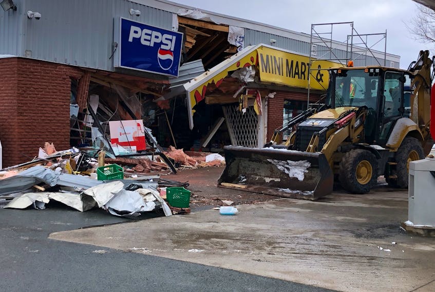 This backhoe/loader was helping clean up debris at a Conception Bay South convenience store Saturday. It was another piece of heavy equipment — a front-end loader — that was suspected of being used in a large-scale break-in robbery at the Manuels business early Saturday morning. — Joe Gibbons/The Telegram