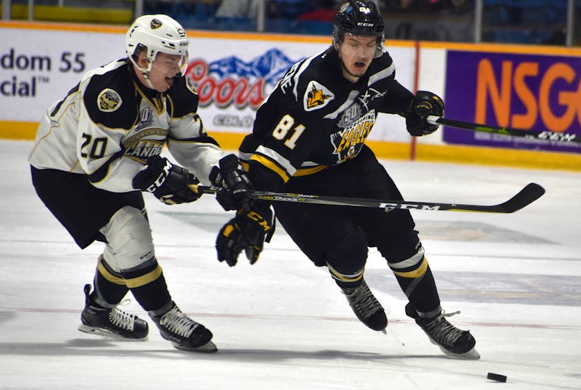 Mathias Laferrière of the Cape Breton Screaming Eagles, right, protects the puck as Thomas Casey of the Charlottetown Islanders attempts to steal it during Quebec Major Junior Hockey League playoff action at Centre 200 on Wednesday. Cape Breton won the game 6-2 and evened the series 2-2.