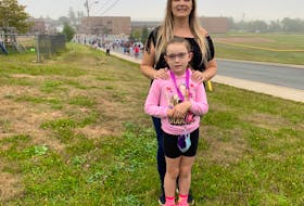Megan Jennex poses with her daughter Layla, before sending her off to her first day of Grade 3 at a school in Dartmouth, N.S., on Tuesday, Sept. 8, 2020.