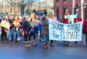 Young strikers march down Main Street in Sackville Friday afternoon, chanting and calling on governments to take action on climate change.