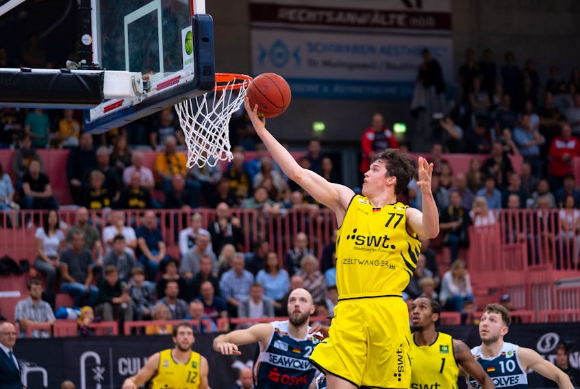 Sven Stammberger of Halifax lays in a shot for the Tubingen Tigers while playing professionally this season in Germany.  Pro and aspiring pro athletes can't spend as much time on the couch as many of us are during the COVID-19 pandemic.