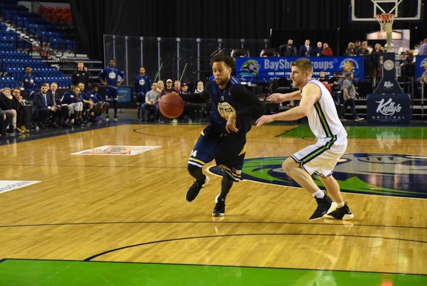 Charles Hinkle (left) shown moving past Connor Wood of the Niagara River Lions, was one of four Edge players with 20 or more points as St. John's defeated Niagara Thursday night. — Niagara River Lions photo via St. John's Edge