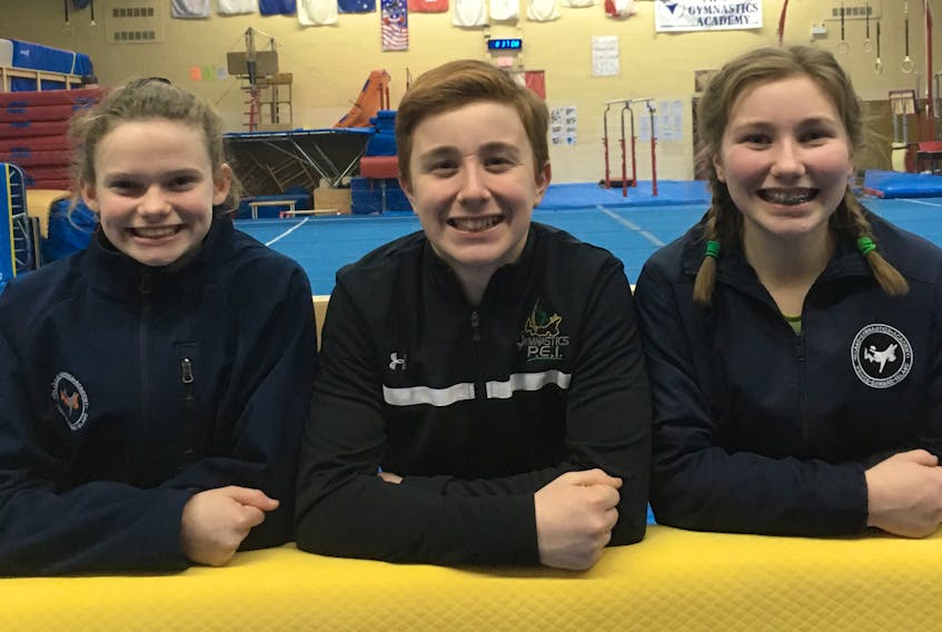 The Prince Edward Classic gymnastics meet is taking place this weekend in Charlottetown. From left, Sophie Mayne, Trent Quinn and Karisa Quinn take a break from training while preparing for the annual competition.
