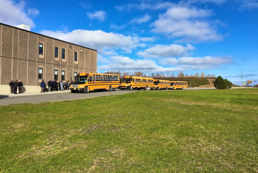 Students at Memorial High School in Sydney Mines catch the bus after classes were suspended for the day on Thursday. Someone detonated a smoke bomb in the high school forcing students and staff to evacuate the building.