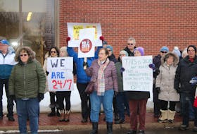 Protesters line the walkway around the Sackville Memorial Hospital as they take part in a rally Thursday afternoon against the recently-announced service cuts.