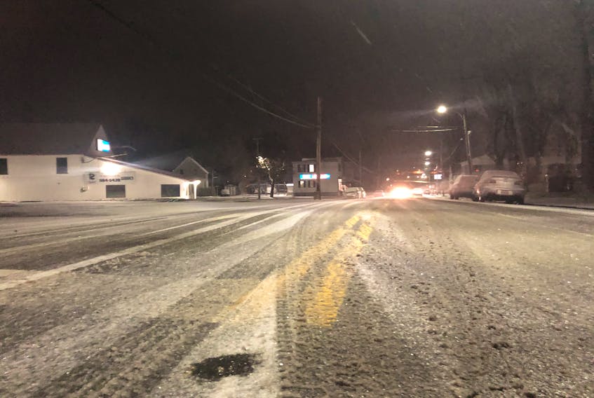 Light snow covers the road at the corner of George and Dorchester Streets in Sydney Wednesday evening. Slippery road conditions have caused accidents across the Cape Breton Regional Municipality.