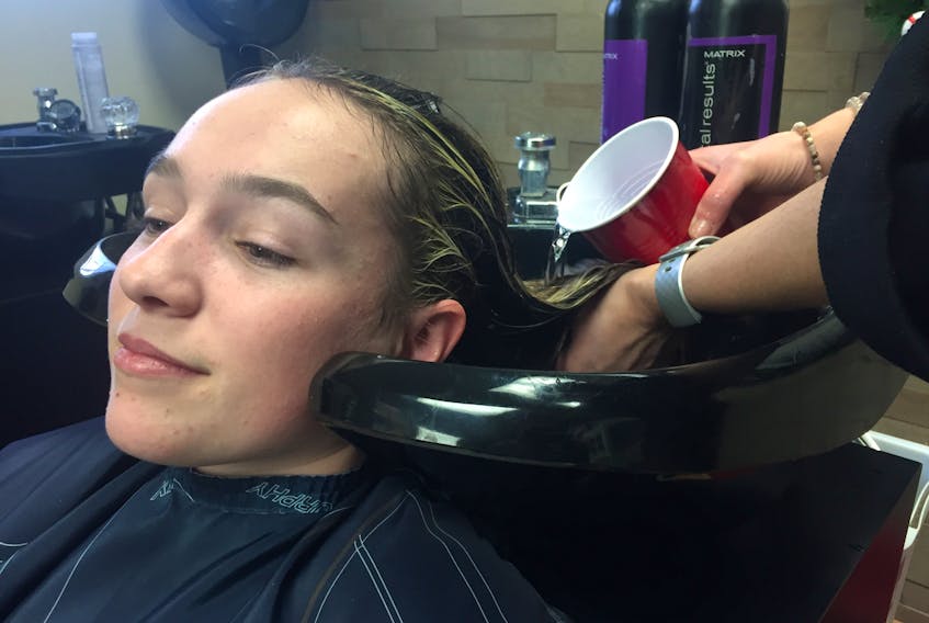 Faucet or solo-cup it's all the same for Madison Baillie getting her hair-cut at Ahead of Hair in Pictou.