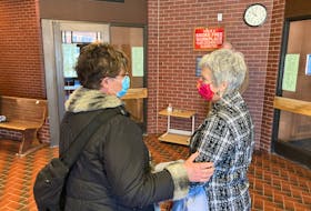 Karin Robertson, right, speaks to a supporter in Kentville provincial court after being acquitted of charges under the Animal Protection Act on Wednesday.