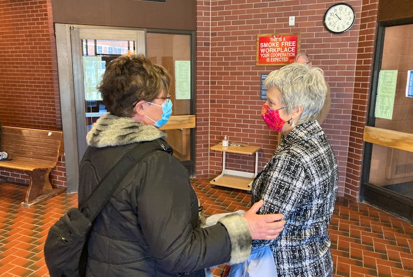 Karin Robertson, right, speaks to a supporter in Kentville provincial court after being acquitted of charges under the Animal Protection Act on Wednesday.