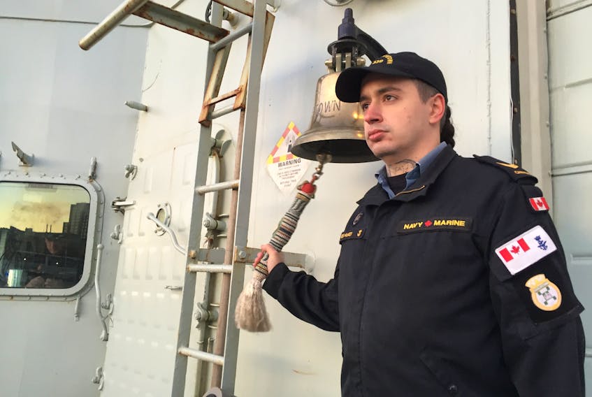 Leading Seaman Andre Belanger rings the bell aboard HMCS Charlottetown in Halifax on Sunday as part of a countrywide Bells of Peace initiative to mark 100 years since the end of World War One. ANDREW RANKIN/ Staff