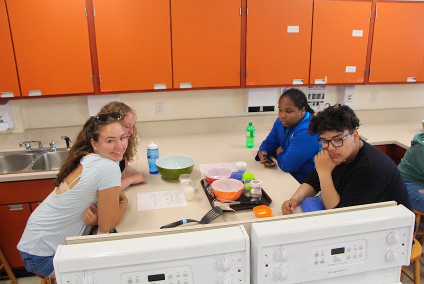 Mya Robie (left) Hannah Harquail, Corell Anderson and Silas Baccouche were among many young students breaking down familiar foods into their constituent ingredients to determine their nutritional value as part of a science camp held at J. Bruce Brown Hall at St. F.X.