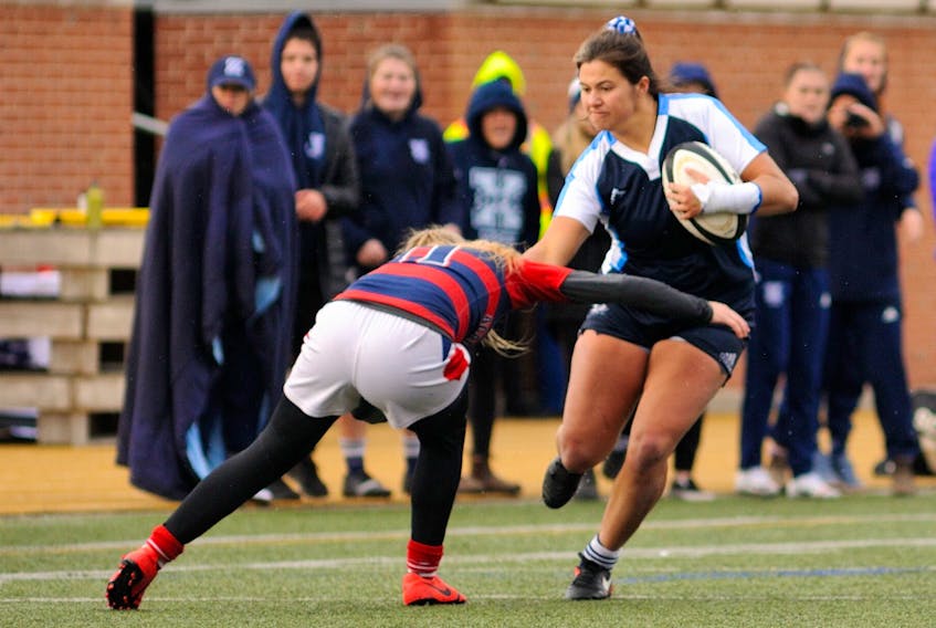 Sammy Nadeau of the St. Francis Xavier X-Women tries to elude an Acadia Axewomen tackle during the Atlantic university rugby championship Saturday afternoon at Oland Stadium. The host X-Women won 29-17. ST. F.X. ATHLETICS