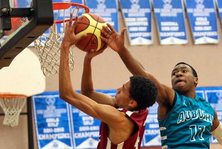 Auburn Drive Eagles’ Johneil Johnson, right, swats at a shot by Citadel Phoenix’s Colin Smith during a metro high boys’ basketball game in 2012. Johnson was a pick of a panelist as one of the greatest high school basketball players in Nova Scotia history.