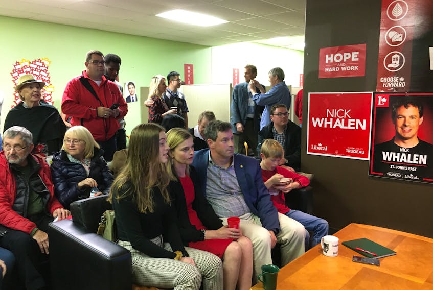 St. John’s East incumbent Liberal Nick Whalen (seated, third from left) and his family — daughter Sophia Whalen, wife Sarah Noble and son Isaac 11,  watch results at his headquarters on Stavanger Drive.