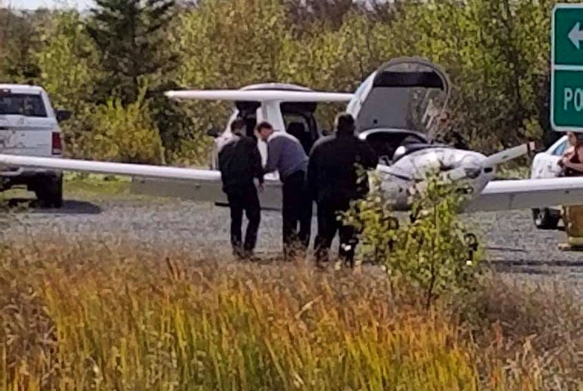 A plane that made an emergency landing near the Confederation Bridge is studied following the incident Monday afternoon. The plane, operated by the Moncton Flight College, was forced to make a landing on the highway near bridge and the Cape Jourimain Nature Centre in Bayfield, N.B.  Robynn Polley photo