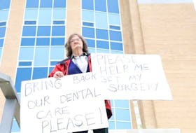 Linda Clarke, 67, stands alone on the steps of Confederation Building in St. John's today to raise awareness of her health issue that is not covered under provincial health care plans or MCP.