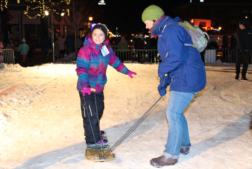 Sam Gilmet, 8, of Glace Bay, N.S., tries out the snowboarding during Aurora: A Downtown Jack Frost Experience presented by The Guardian on Saturday night.