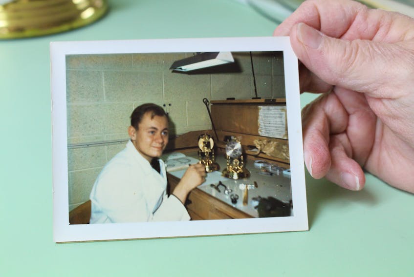 A photograph of Danny Amero in clock and watch repair school, he's been in the business for 51 years.