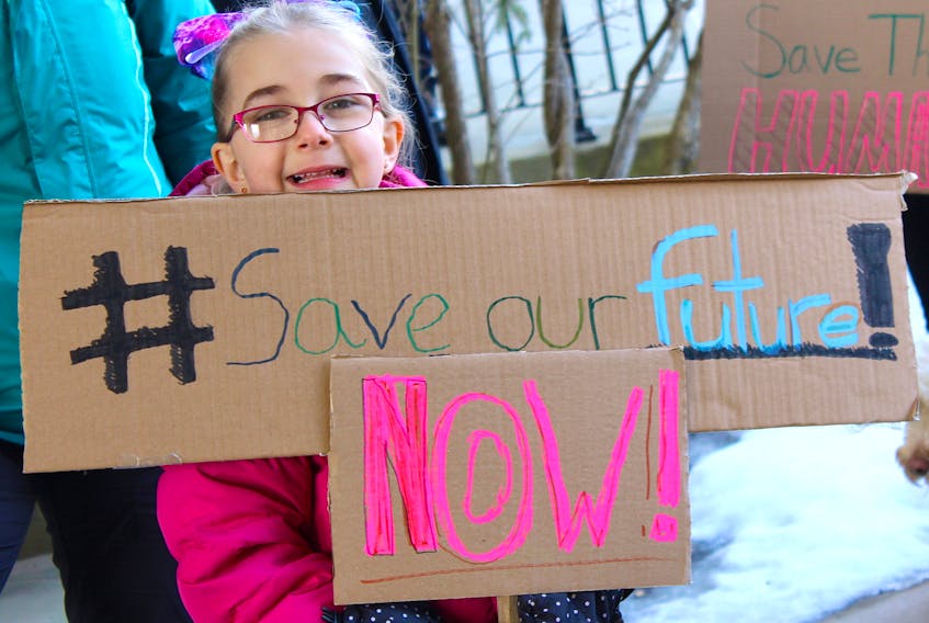 Sackville students of all ages took part in Friday's climate strike, including Chloe Roness-Allen who used a handmade cardboard sign to make her plea.