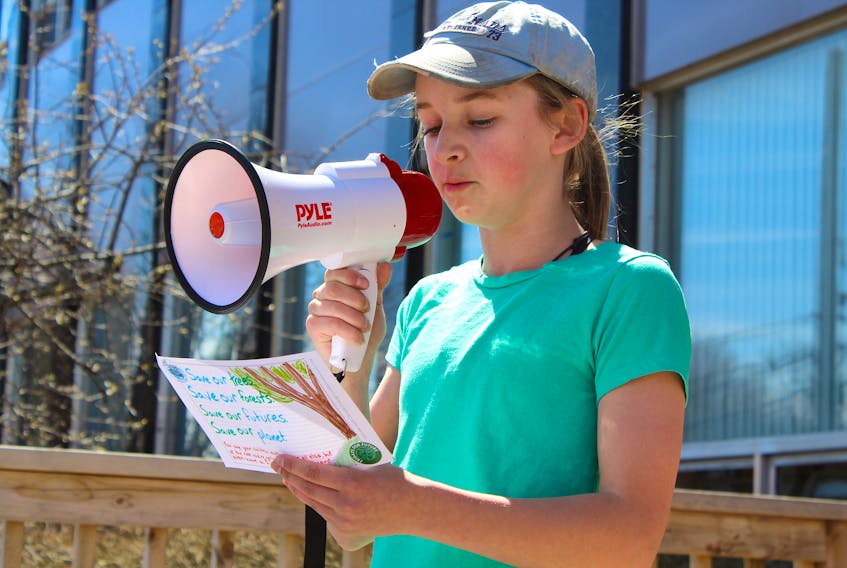 Marshview Middle School student Quinn MacAskill speaks to the students taking part in Friday's climate strike in front of the Sackville post office. The youth sent postcards to the federal Minister of Environment asking for the government to implement a bold new climate policy.
