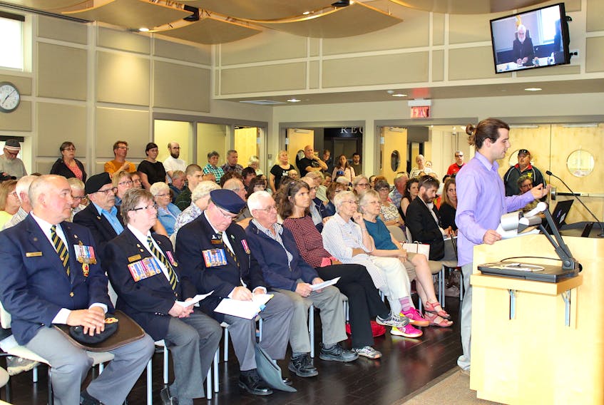 Sackville resident Alex Thomas, right, speaks out on his reasons why he feels the Cougar is not an appropriate monument for Memorial Park during a packed town hall meeting Tuesday evening.