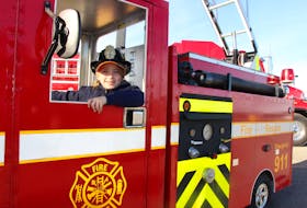 Caileag Oakley of Linacy takes the driver’s seat in model fire truck on display at the Pictou County Firefighters Association’s Show and Shine Saturday in New Glasgow.  The truck was built by Westville Fire Chief Ken Dunn and was a hit with young and old at the event.