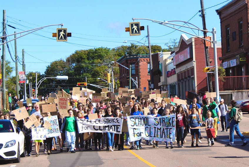 Sackville's climate strikers march down Main Street on Friday morning.
