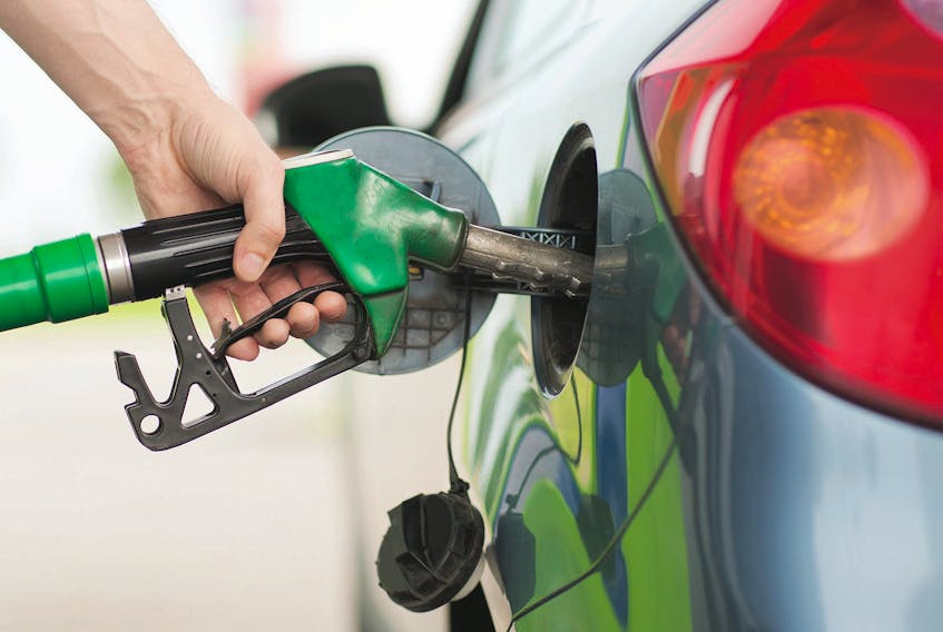 A man pumping gasoline into his car
