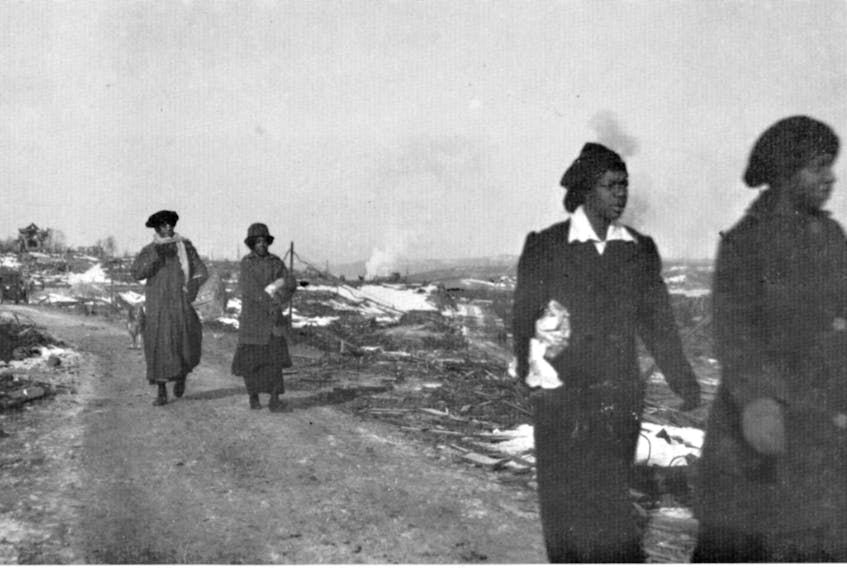 Four women walk through their devastated community of Africville after the Halifax Explosion.  City Of Toronto Archives