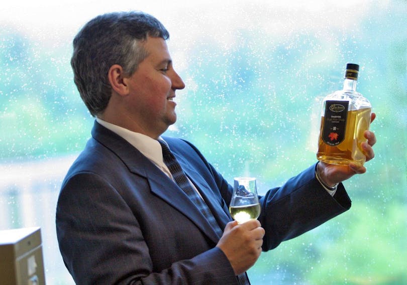 Glenora Distillers president Lauchie MacLean looks over a bottle of Glen Breton single malt whiskey in the company’s Bedford office in 2009.