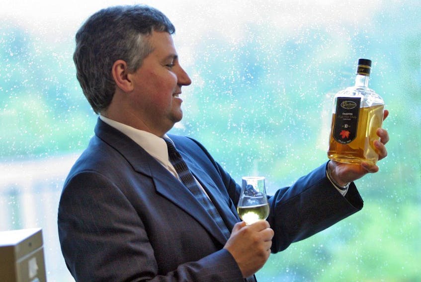Glenora Distillers president Lauchie MacLean looks over a bottle of Glen Breton single malt whiskey in the company’s Bedford office in 2009.