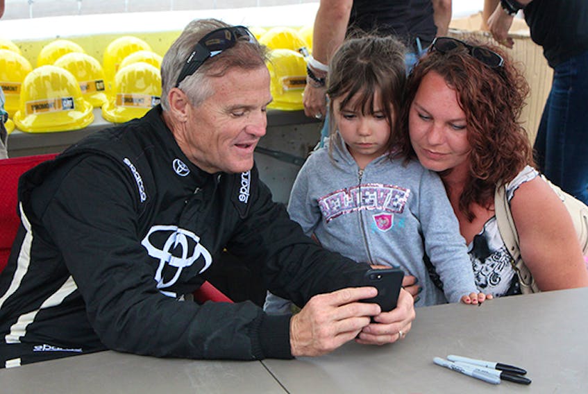 NASCAR legend Kenny Wallace shares a moment with Alexis MacEachern and Holly Hartman Saturday afternoon (July 14) during an autograph session prior to the IWK 250 at Riverside International Speedway. Corey LeBlanc