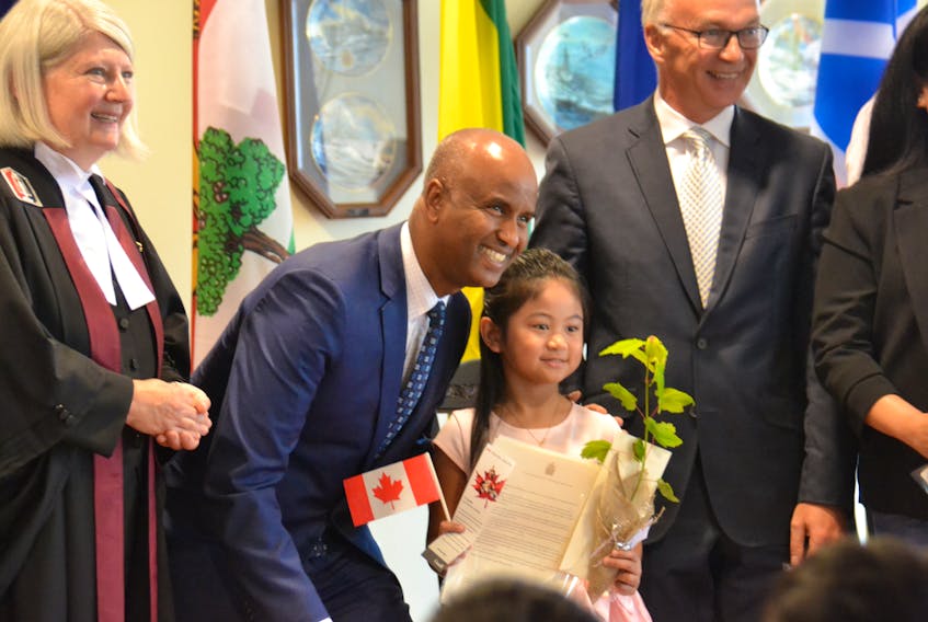 Seven-year-old Atasha Nocos Villesis poses for a photo with federal Immigration Minister Ahmed Hussen at a citizenship ceremony in Charlottetown on Thursday. Hussen attended the official opening of an Immigration, Refugee and Citizenship Canada office in Charlottetown.