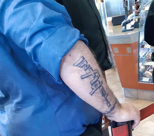 The Royal Canadian Navy is looking to identify a sailor with the word infidel tattooed in the shape of a rifle on his arm.