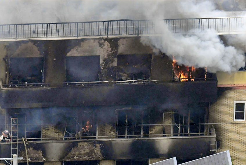 An aerial view shows smoke and flame rising from the three-storey Kyoto Animation building, which was torched in Kyoto, western Japan, Thursday, July 18, 2019. - Kyodo / via Reuters