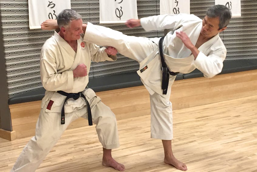 John DeMont gets a close-up view of eight-degree karate black belt Tony Tam's mawashi geri.