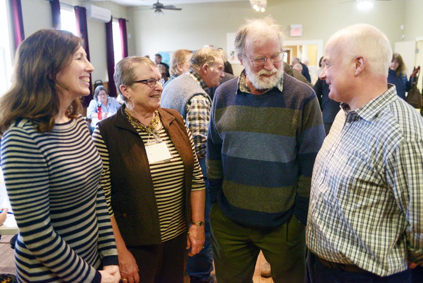 Cooper Institute’s Debbie Theuerkauf, left, chats with National Farmers’ Union women’s district director Edith Ling; NFU and Cooper Institute member Reg Phelan and NFU district director Douglas Campbell, following a social justice symposium focused on land protection on Saturday. Theuerkauf was an organizer for the event while Ling, Phelan and Campbell, were all part of a panel discussion on strengthening land protection on P.E.I. MITCH MACDONALD/THE GUARDIAN