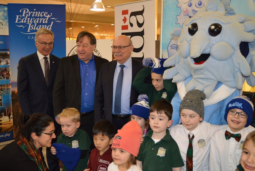 Charlottetown MP Sean Casey, from left, Charlottetown Mayor Clifford Lee and John Cudmore, chairman of the Jack Frost Winterfest pose for a photo with children from Montessori School in Charlottetown and the Jack Frost mascot at the Jack Frost pres conference in Charlottetown on Thursday.
