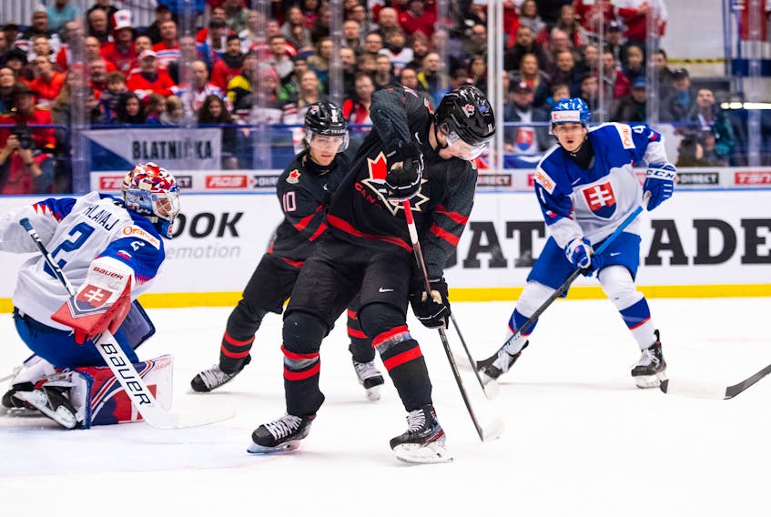 Canada’s Alexis Lafreniere, front, and Raphael Lavoie look for the puck during IIHF world junior quarterfinal action against Slovakia on Thursday in Ostrava, Czech Republic.  Reuters