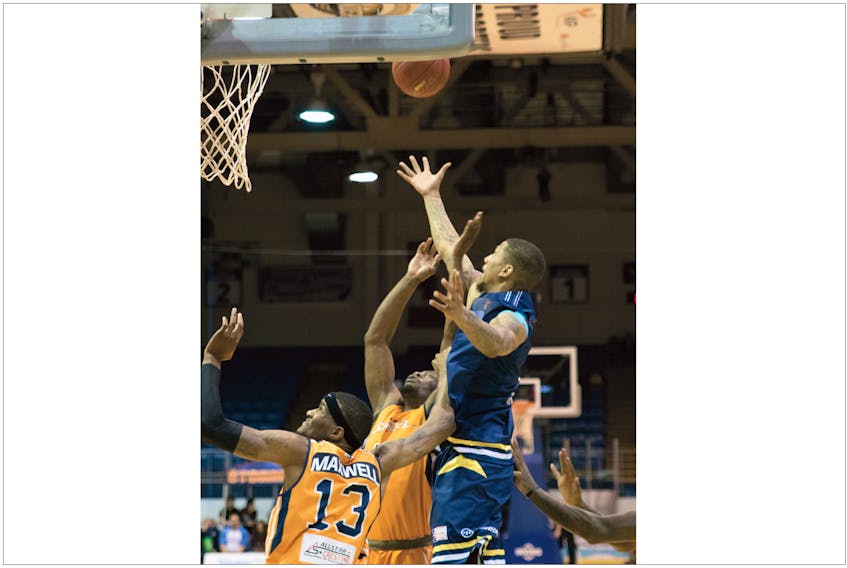 Island Storm/Stephene Poirier — Jarion Henry of the St. John’s Edge (right) goes high to grab a rebound among Island Storm defenders, including Du’Vaughm Maxwell (13), in Charlottetown, P.E.I., Saturday. The Edge won their inaugural game, shading the Storm 97-96.