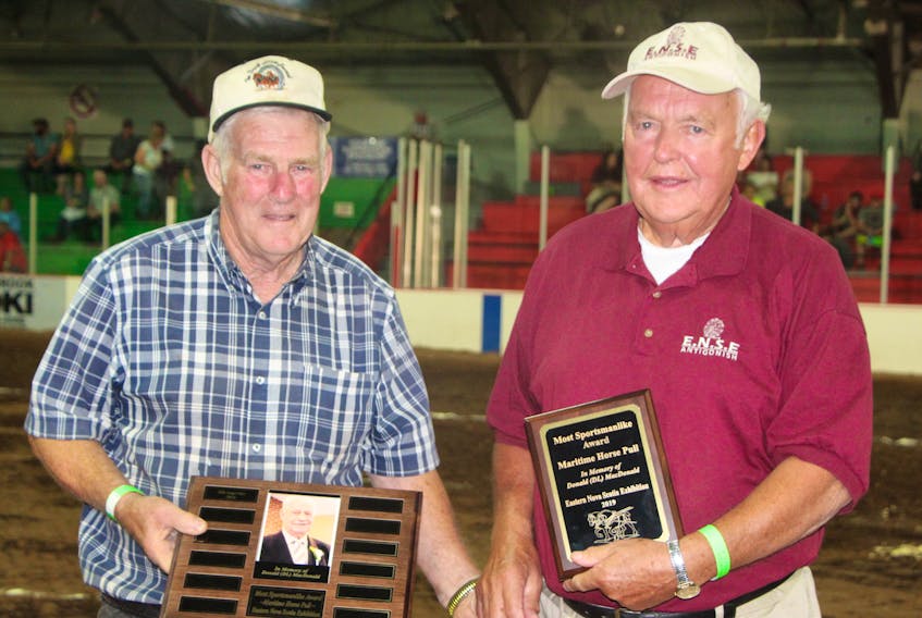 ENSE manager Donald MacLellan (right) presents Jim Kell with the Most Sportsmanlike Award – Maritime Horse Pull – in memory of Donald ‘DL’ MacDonald, Sunday (Sept. 1) afternoon at the Antigonish Arena.