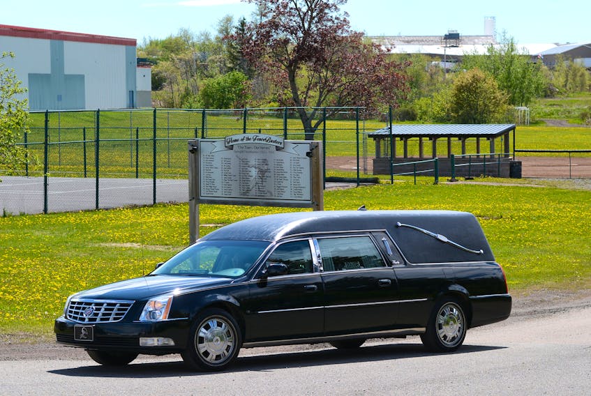 The hearse, carrying the body of Jim 'Pokey' Melanson stops by the Fencebusters baseball complex named in his and his wife, Jewell's, honour following his funeral on Tuesday in Springhill.
