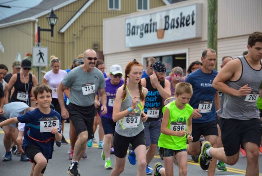And they’re off. Participants of all ages taking part in Saturday’s annual Johnny Miles 5k race head down Main Street in Sydney Mines.
