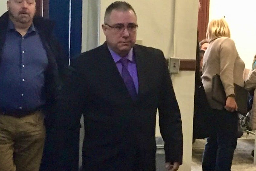 Det. Const. Joseph Farrow arrives at Halifax provincial court last December ahead of Sgt. Dean Stienburg, president of the union that represents Halifax Regional Police officers. Farrow pleaded guilty to a charge of assault and was given a conditional discharge with two years' probation Monday.