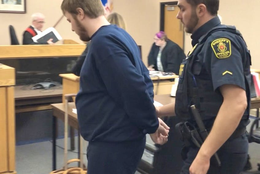 A sheriff escorts Joshua Steele-Young from a courtroom at provincial court in St. John’s after his sentencing Wednesday. Tara Bradbury/The Telegram